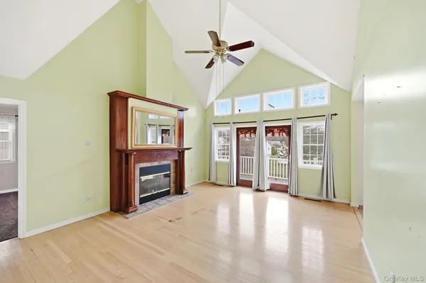 a view of an empty room with a fireplace and a window