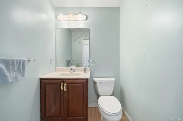 a bathroom with a toilet a sink and mirror