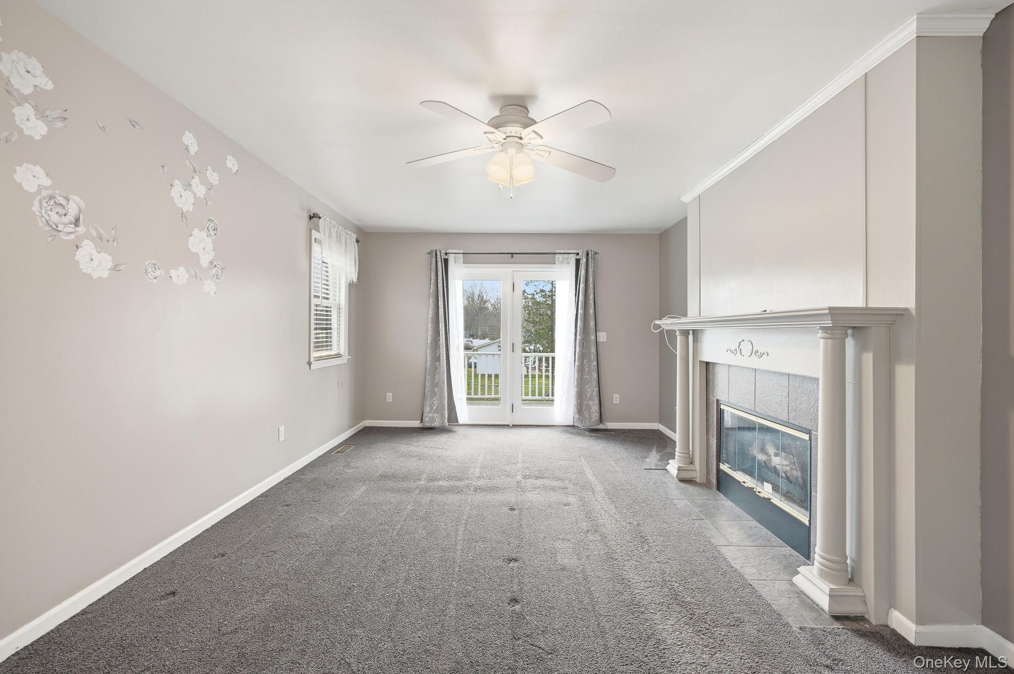 186 Violet Avenue Poughkeepsie, NY 12601 - Photo 29 of 50 a view of an empty room with a fireplace and a window