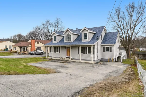 a front view of a house with a garden and pathway