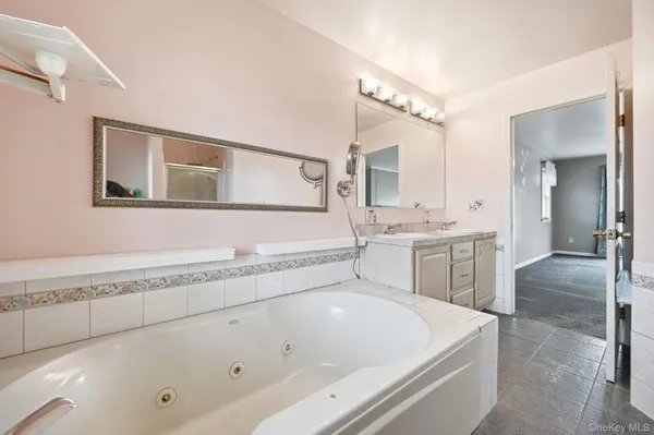 a white bath tub sitting next to a bathroom sink