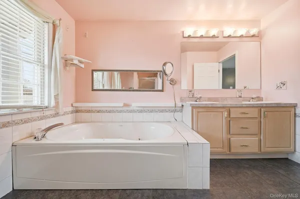 a spacious bathroom with a bathtub and a sink