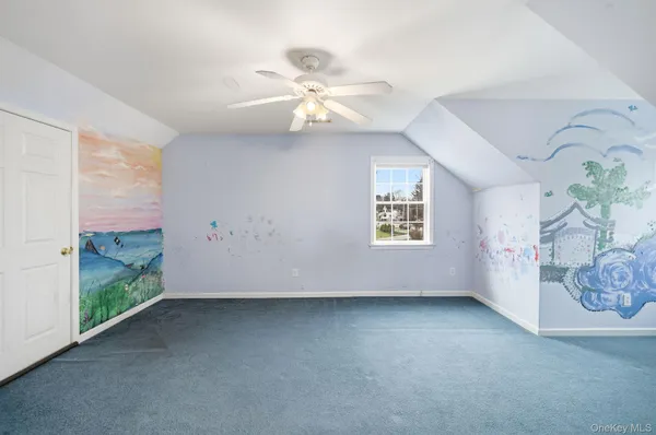 a view of a livingroom with a ceiling fan and window