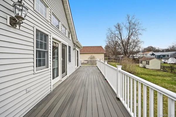 a view of a wooden deck and lake with trees in the background