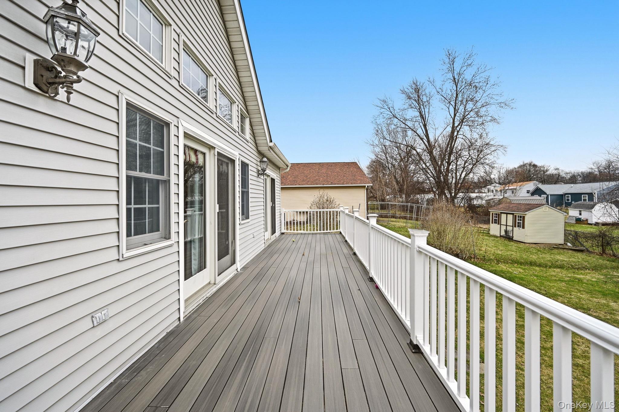 186 Violet Avenue Poughkeepsie, NY 12601 - Photo 45 of 50 a view of a wooden deck and lake with trees in the background