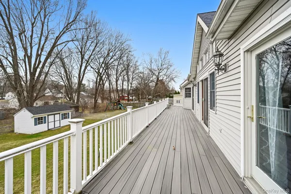 a view of a balcony with wooden floor and fence