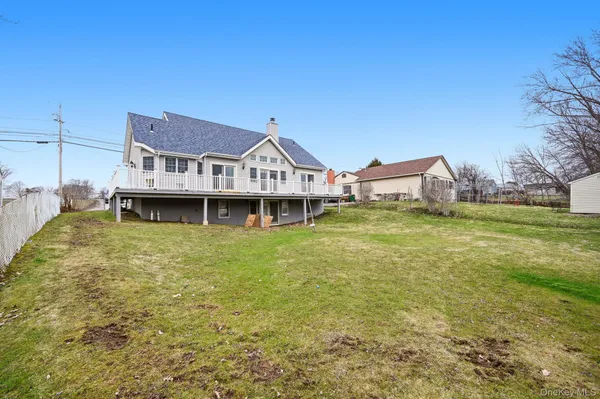 a front view of a house with a garden and deck