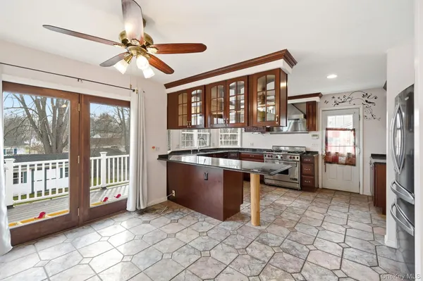 a large kitchen with cabinets and stainless steel appliances