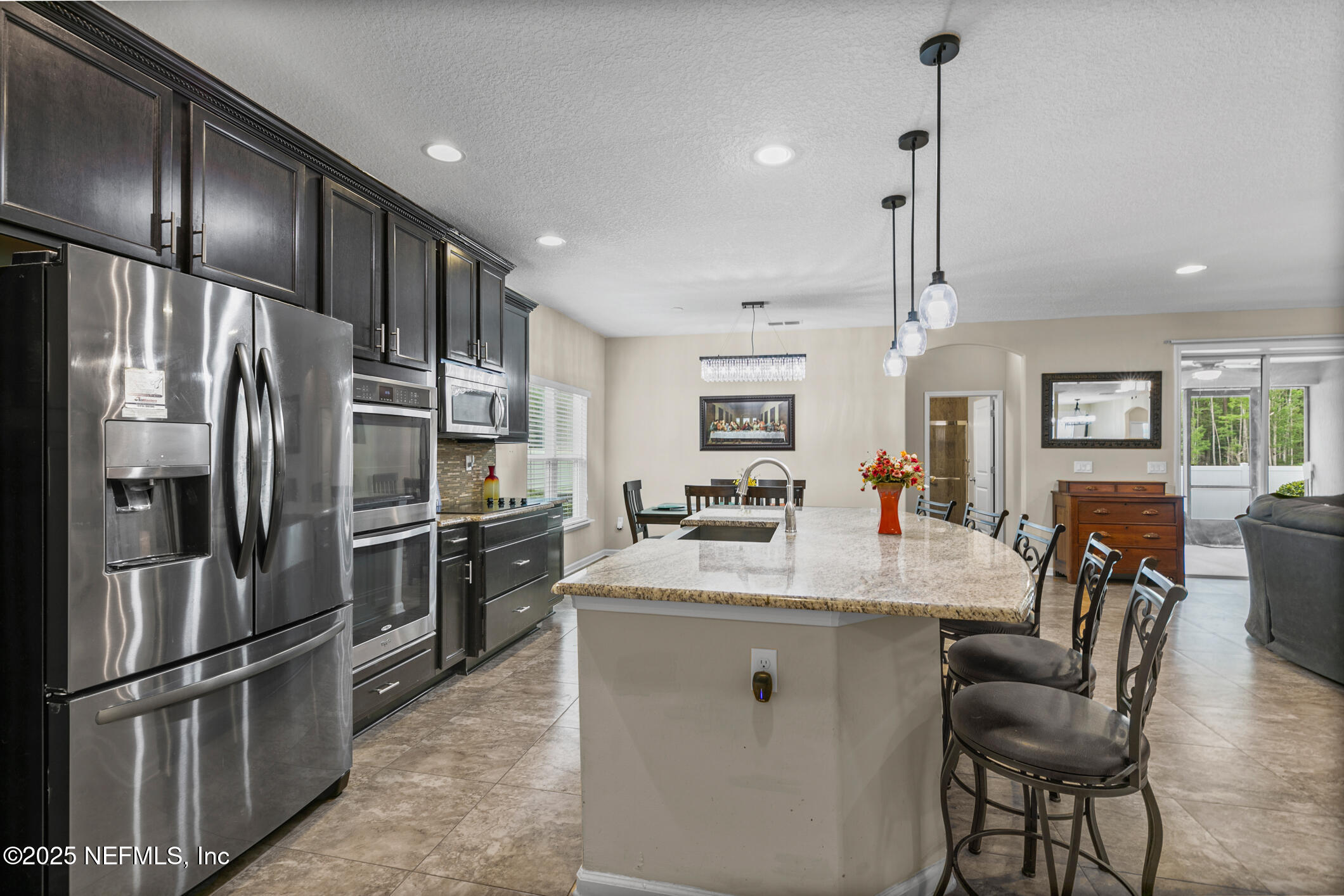 200 Ellsworth Circle St. Johns, FL 32259 - Photo 14 of 48 a kitchen with stainless steel appliances granite countertop a refrigerator a stove a sink a dining table and chairs with wooden floor
