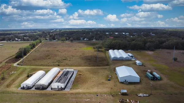 an aerial view of a house with yard