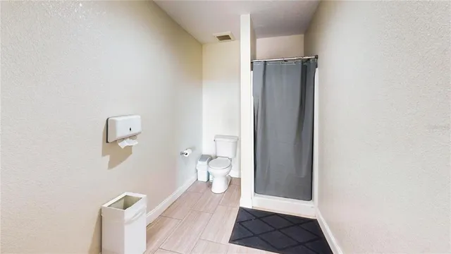 a bathroom with a shower and a toilet