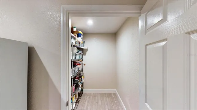 a view of a hallway with a white walls and stairs