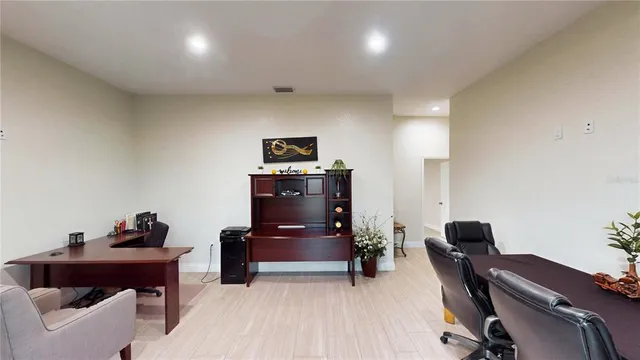 a living room with furniture and a piano