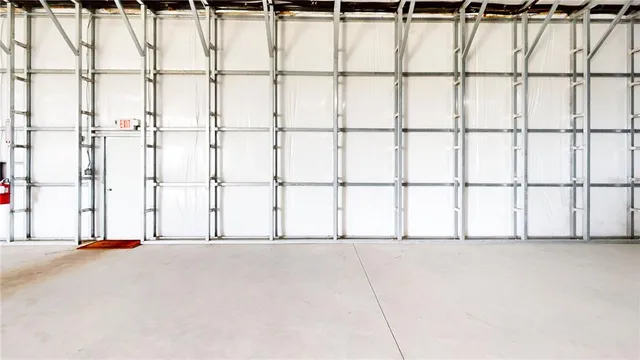 a view of garage with a car parked