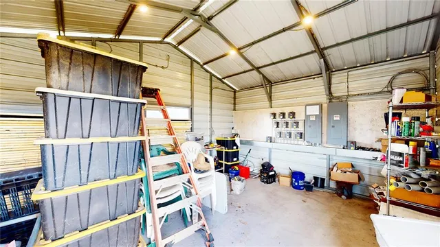 a white bed sitting in a kitchen next to a window