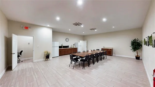 a view of a dining hall with furniture and wooden floor