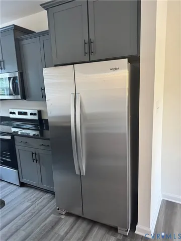 a kitchen with a sink a mirror and cabinets