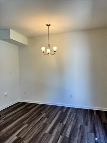an empty room with windows and ceiling fan