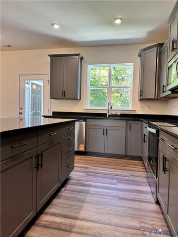 a kitchen with wooden floors and a sink