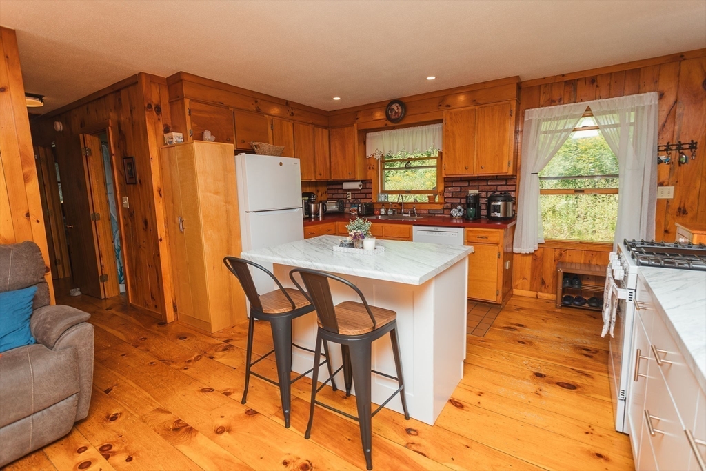 90 West Hawley Road Hawley, MA 01339 - Photo 7 of 34 a dining room with furniture a window and a kitchen view