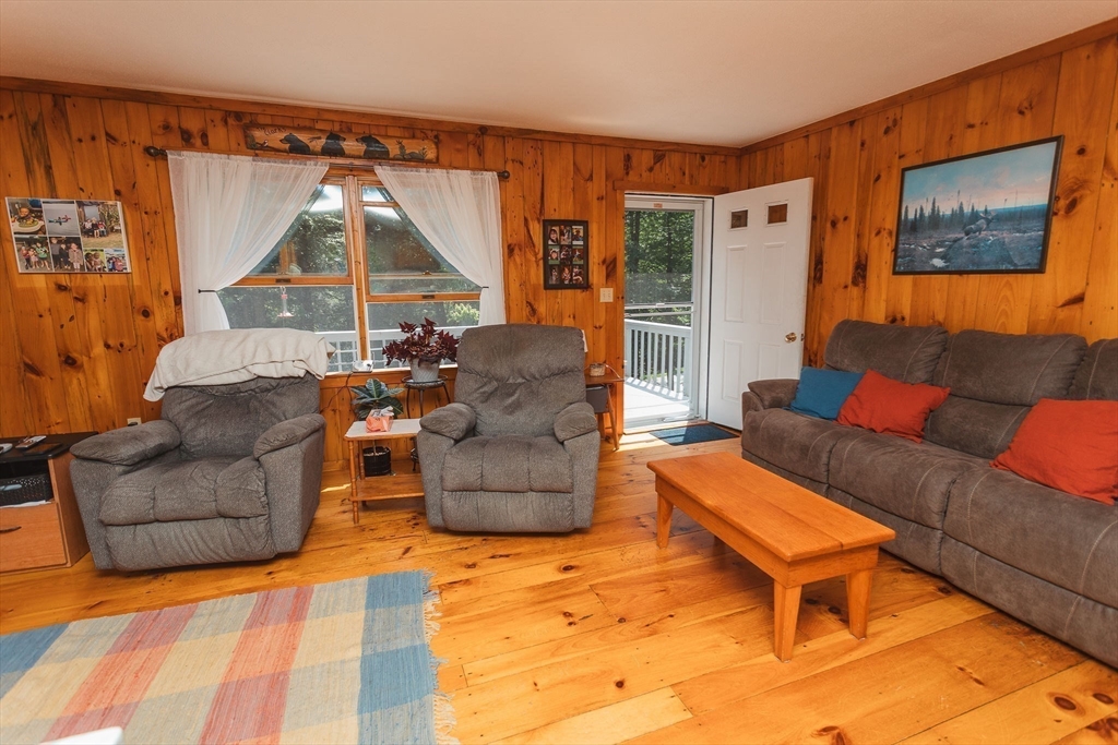 90 West Hawley Road Hawley, MA 01339 - Photo 10 of 34 a living room with furniture a flat screen tv and a floor to ceiling window