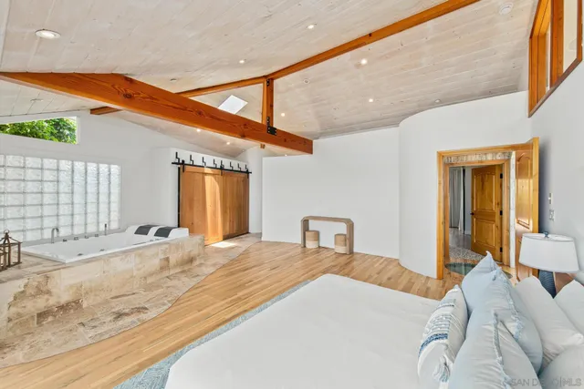 a living room with furniture a wooden floor and next to a window