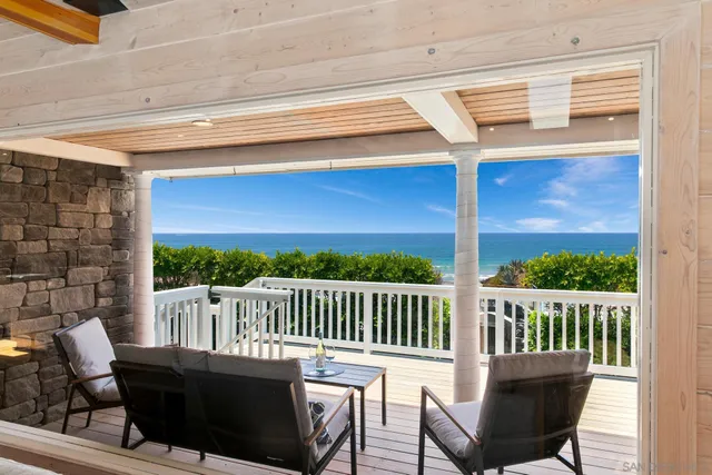 a view of balcony with wooden floor and fence