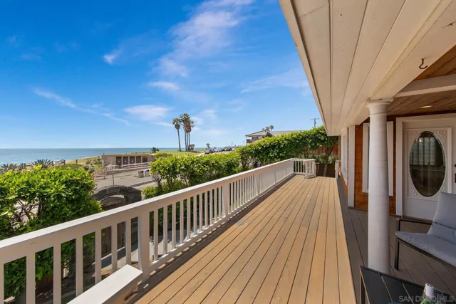a bedroom with a bed and a balcony