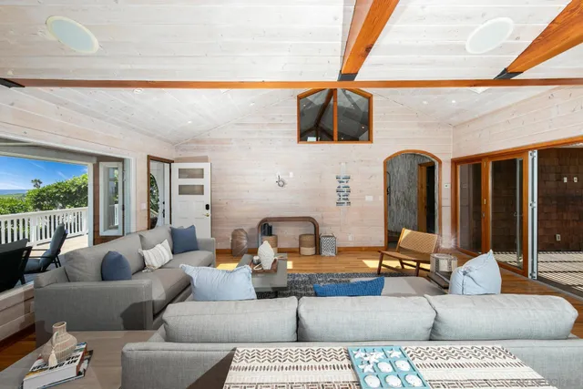 a bedroom with a bed and a dresser with wooden floor