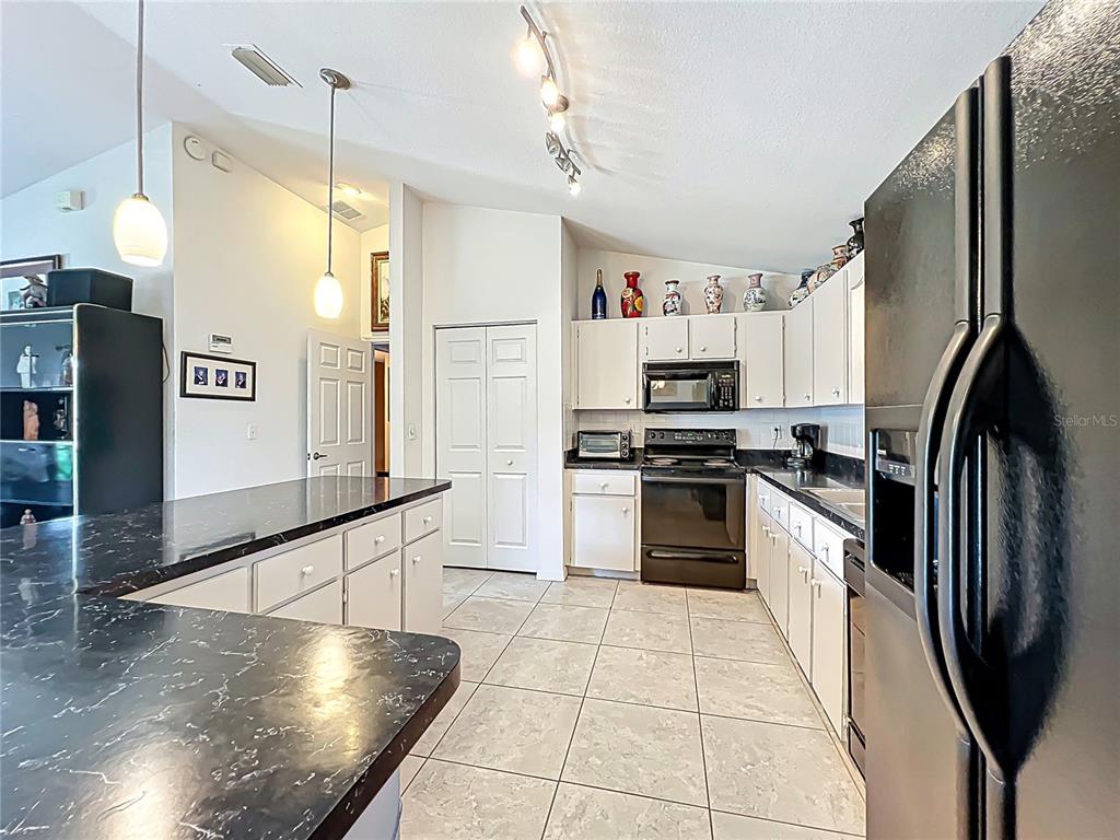 22163 Southwest Edgewater Boulevard Dunnellon, FL 34431 - Photo 16 of 78 a kitchen with stainless steel appliances granite countertop a refrigerator a stove and a sink