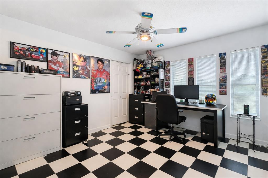 22163 Southwest Edgewater Boulevard Dunnellon, FL 34431 - Photo 28 of 78 a living room with a black white checkered floor
