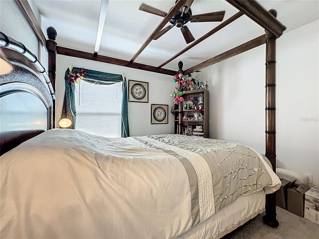 22163 Southwest Edgewater Boulevard Dunnellon, FL 34431 - Photo 31 of 78 a bedroom with a bed and a mirror