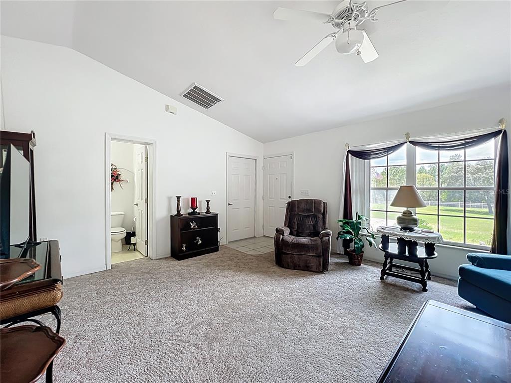 22163 Southwest Edgewater Boulevard Dunnellon, FL 34431 - Photo 44 of 78 a living room with furniture and a flat screen tv