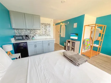a bedroom with a bed and a flat tv screen