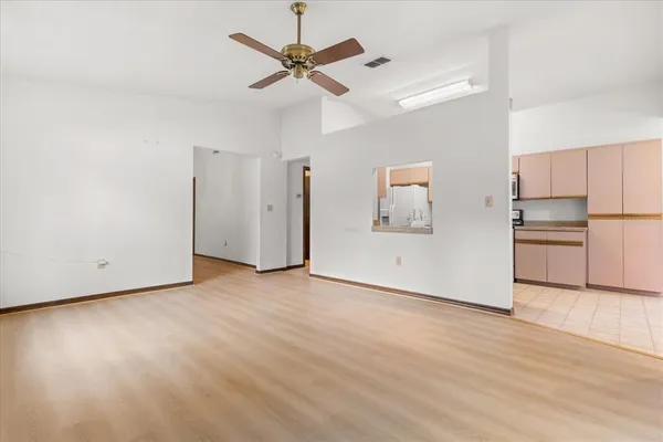 a view of a kitchen with a dishwasher cabinets and wooden floor