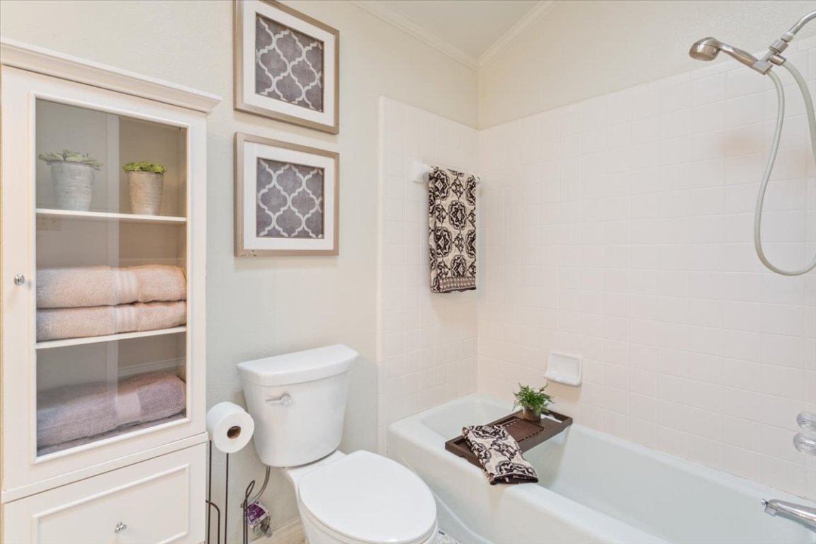 2217 Stagecoach Trail Temple, TX 76502 - Photo 30 of 39 a white toilet sitting next to a bathroom sink and tub