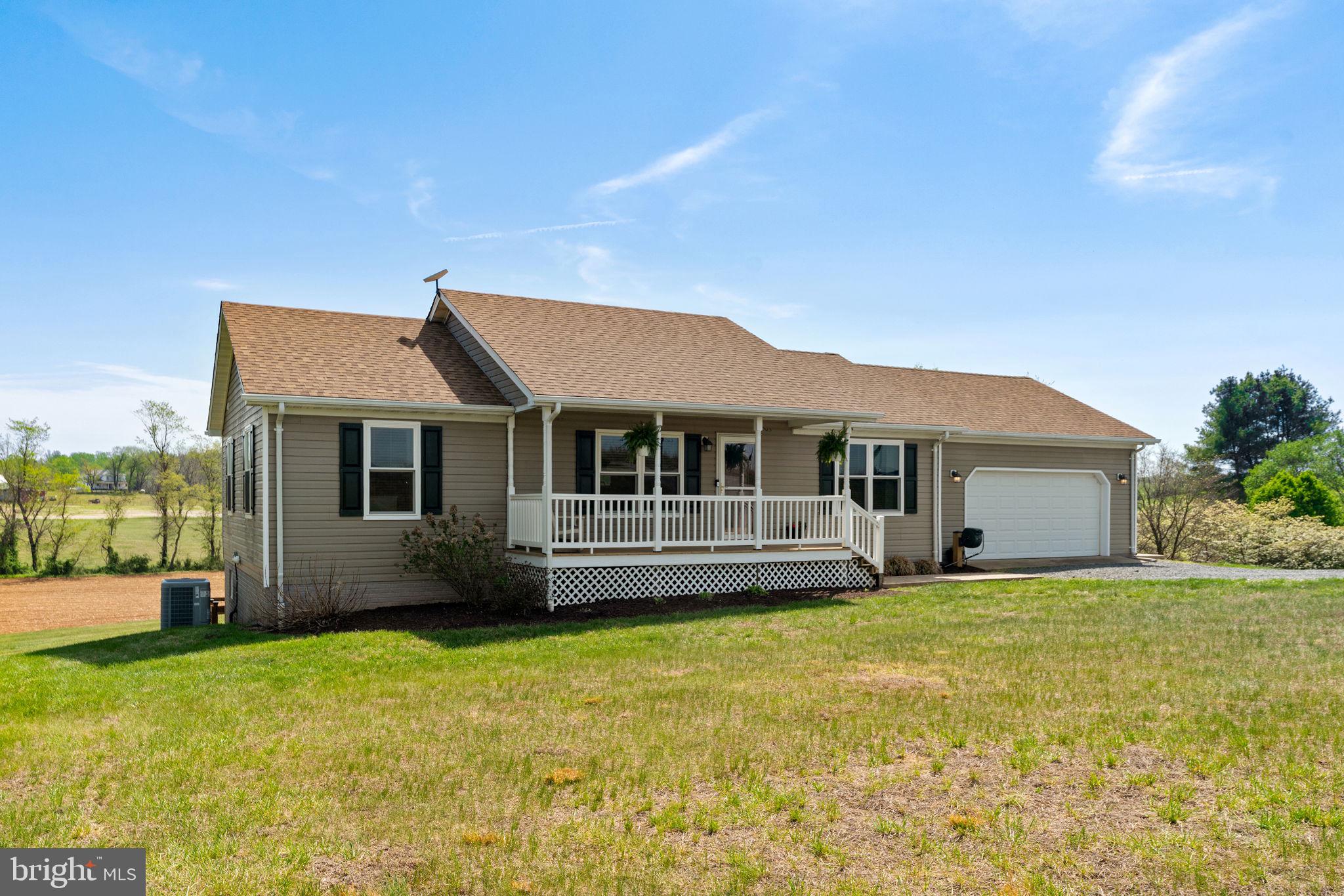 1388 Novum Church Road Reva, VA 22735 - Photo 1 of 65 a front view of a house with a garden