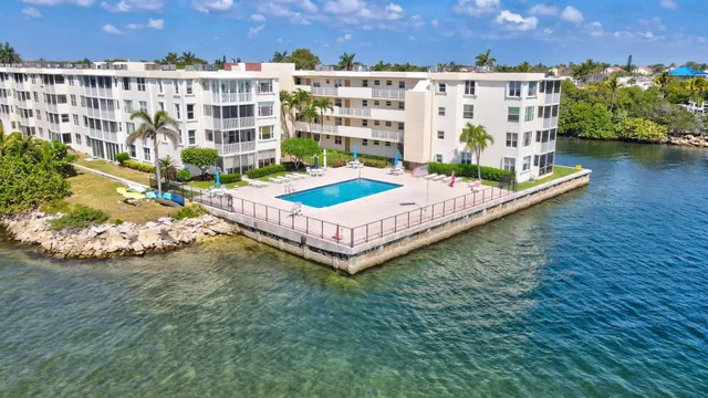 an aerial view of a house with a garden and lake view