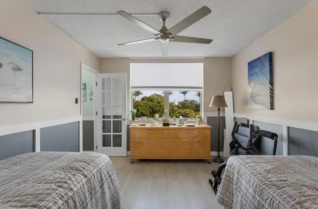 a bedroom with a bed and ceiling fan