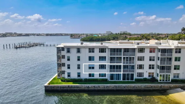 a view of building with river and trees in the background