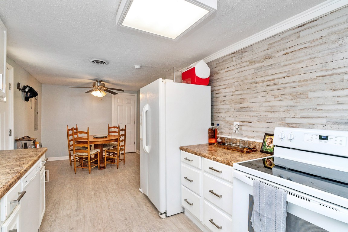 425 Keysburg Road Adams, TN 37010 - Photo 15 of 45 a kitchen with stainless steel appliances kitchen island granite countertop a table and chairs in it
