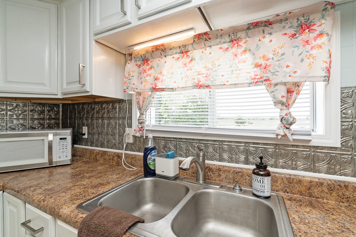 425 Keysburg Road Adams, TN 37010 - Photo 19 of 45 a bathroom with a granite countertop sink and a window