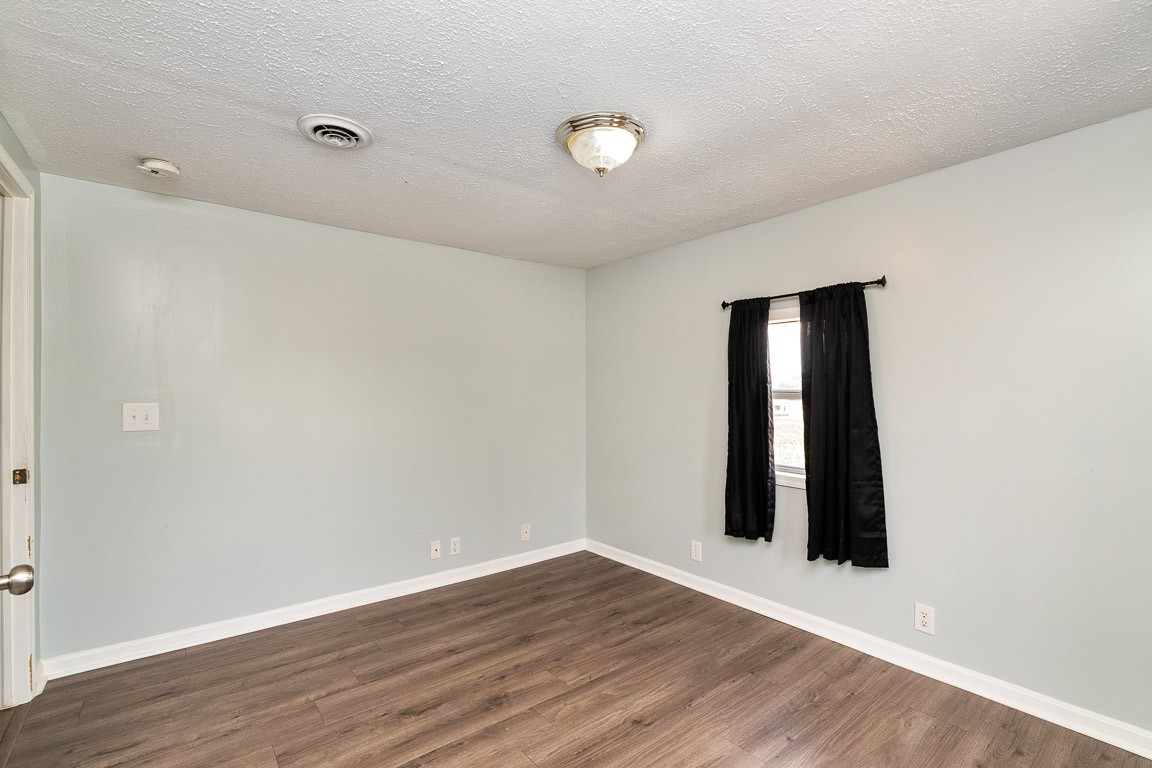 425 Keysburg Road Adams, TN 37010 - Photo 24 of 45 an empty room with wooden floor and windows