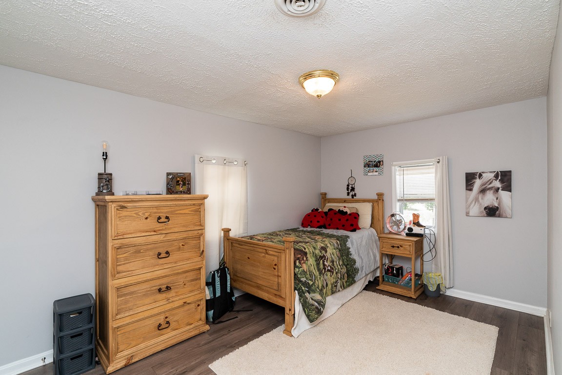 425 Keysburg Road Adams, TN 37010 - Photo 28 of 45 a bedroom with a bed and wooden floor