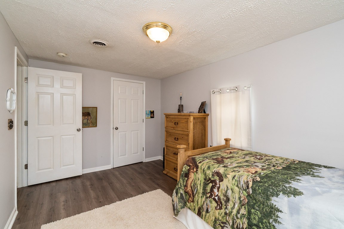 425 Keysburg Road Adams, TN 37010 - Photo 30 of 45 a bedroom with a bed and wooden floor
