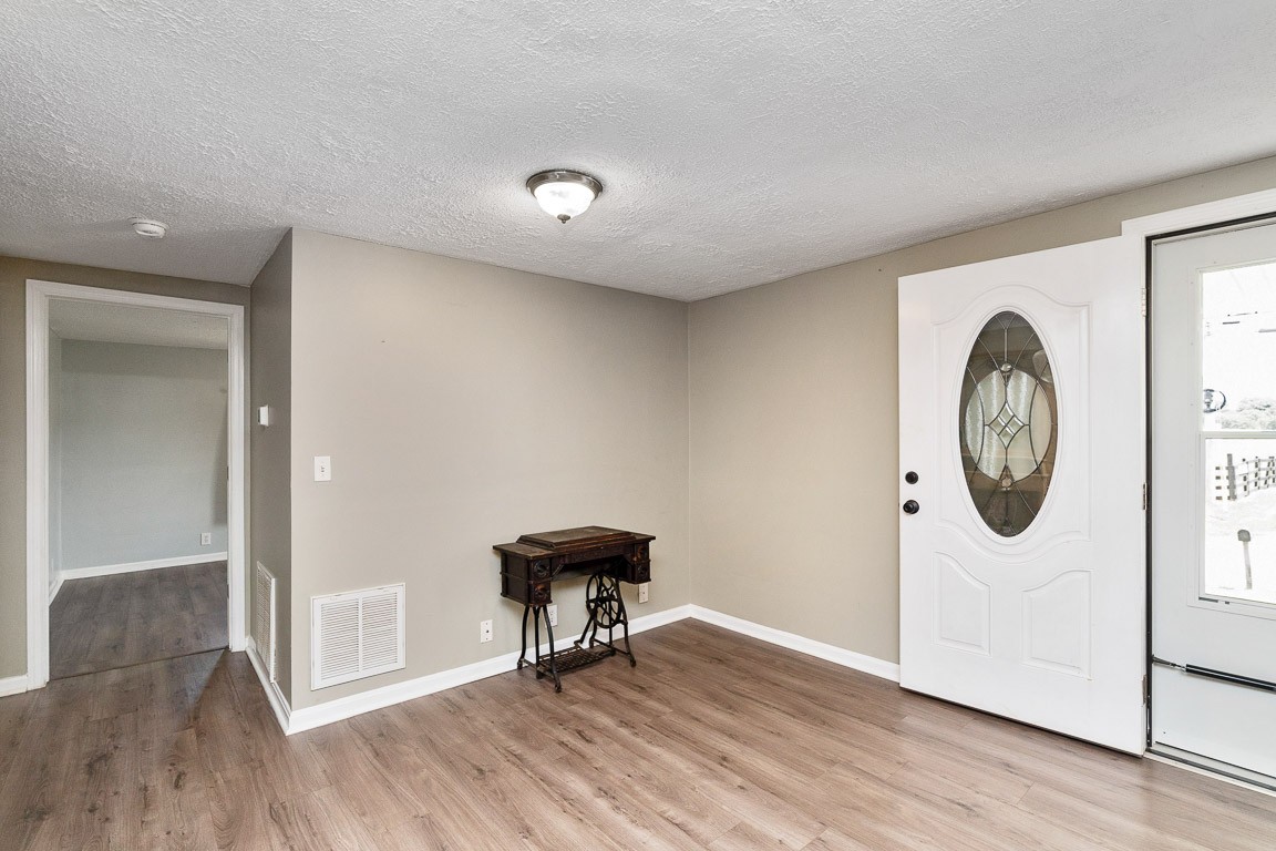 425 Keysburg Road Adams, TN 37010 - Photo 3 of 45 an empty room with wooden floor and a window