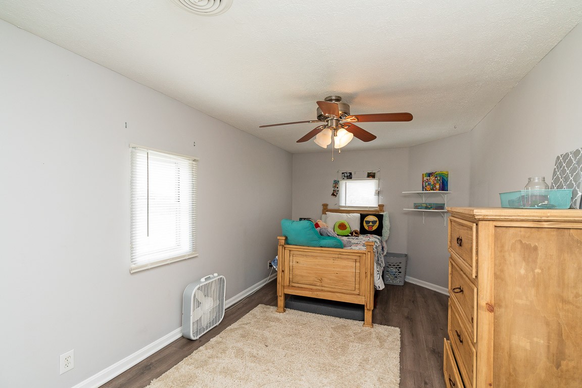 425 Keysburg Road Adams, TN 37010 - Photo 31 of 45 a bedroom with a bed and a chandelier