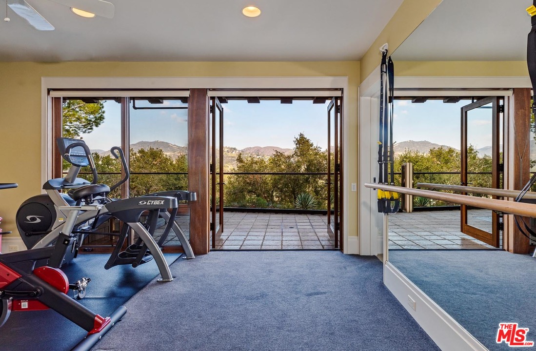 1870 Mango Way Los Angeles, CA 90049 - Photo 17 of 28 a view of a room with gym equipment