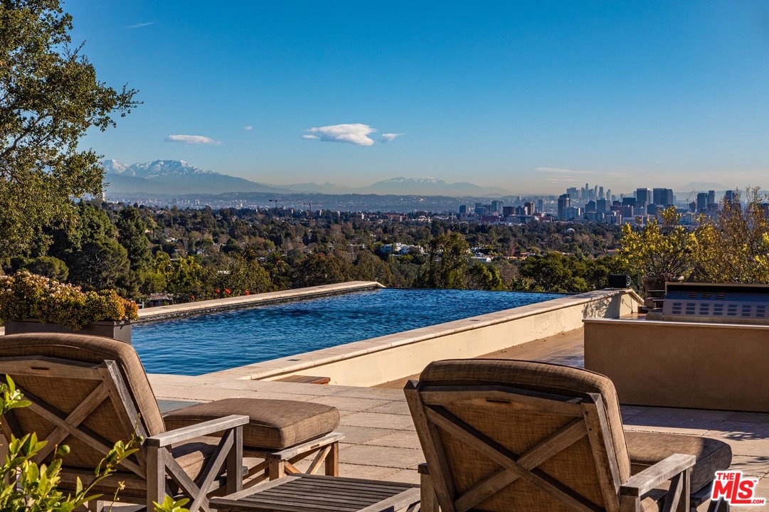 1870 Mango Way Los Angeles, CA 90049 - Photo 3 of 28 a view of a chairs and table on the terrace