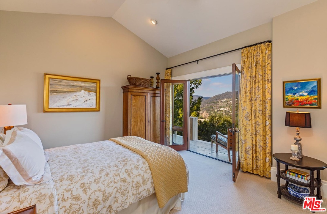 1870 Mango Way Los Angeles, CA 90049 - Photo 22 of 28 a bedroom with a bed and a flat screen tv